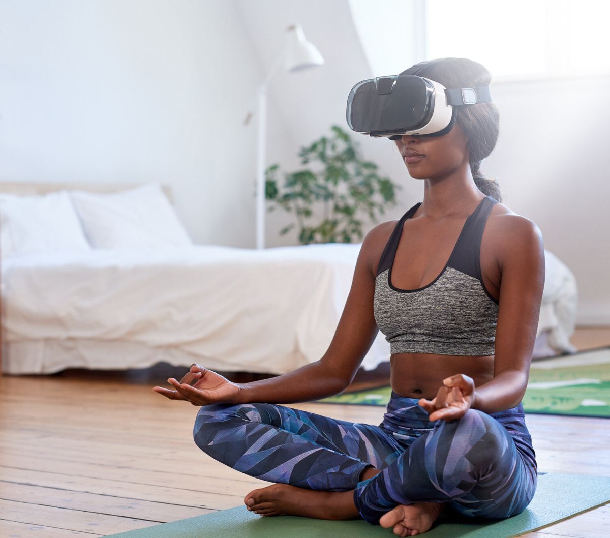 A woman doing yoga at home while wearing a VR headset